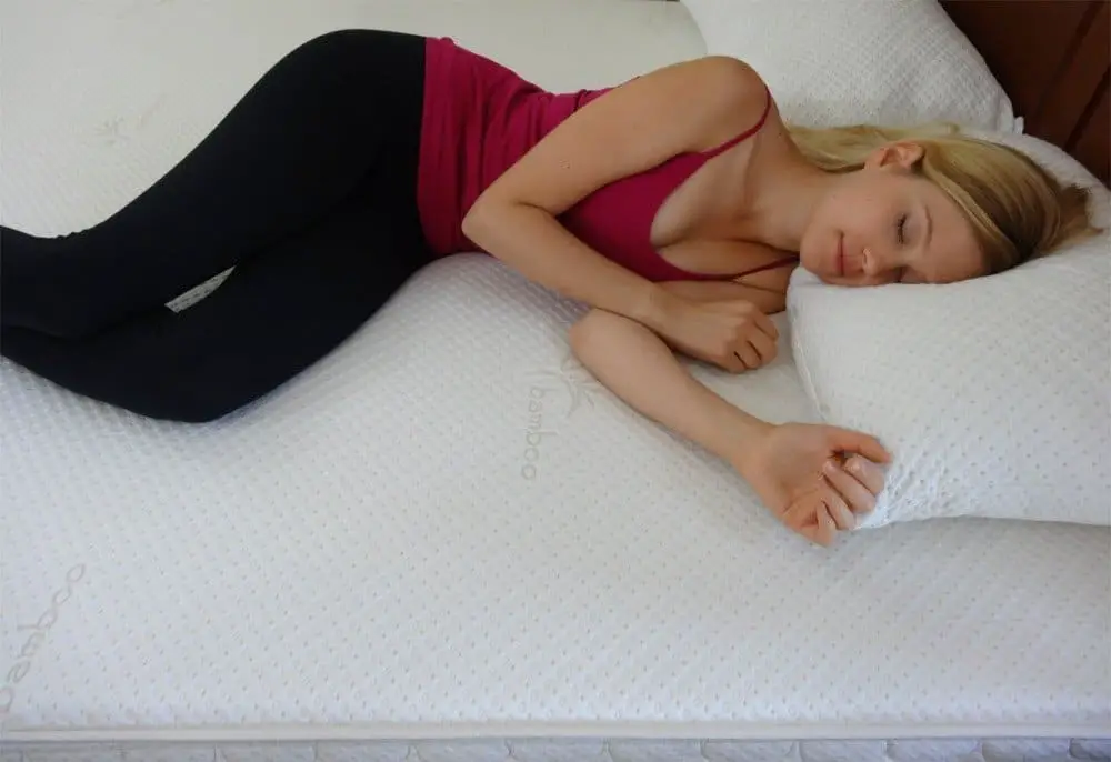 young woman asleep on a Snuggle-Pedic mattress