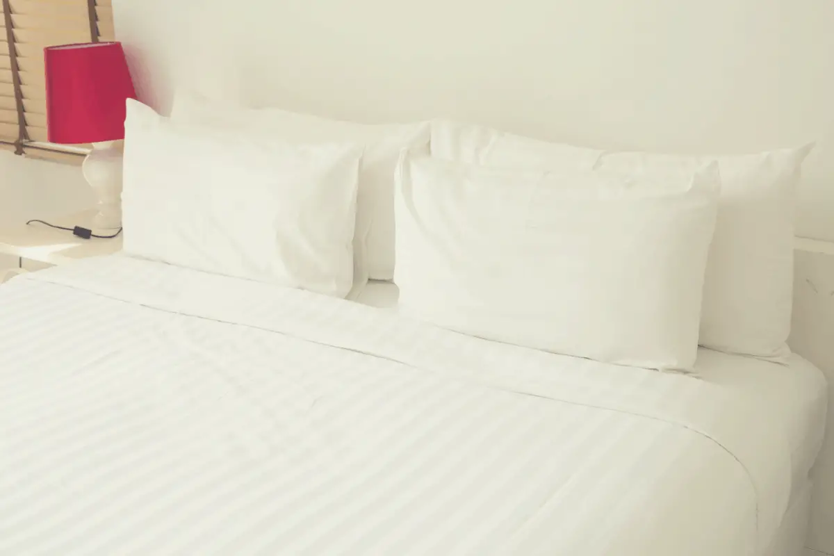 white premium bed sheets laid on a bed