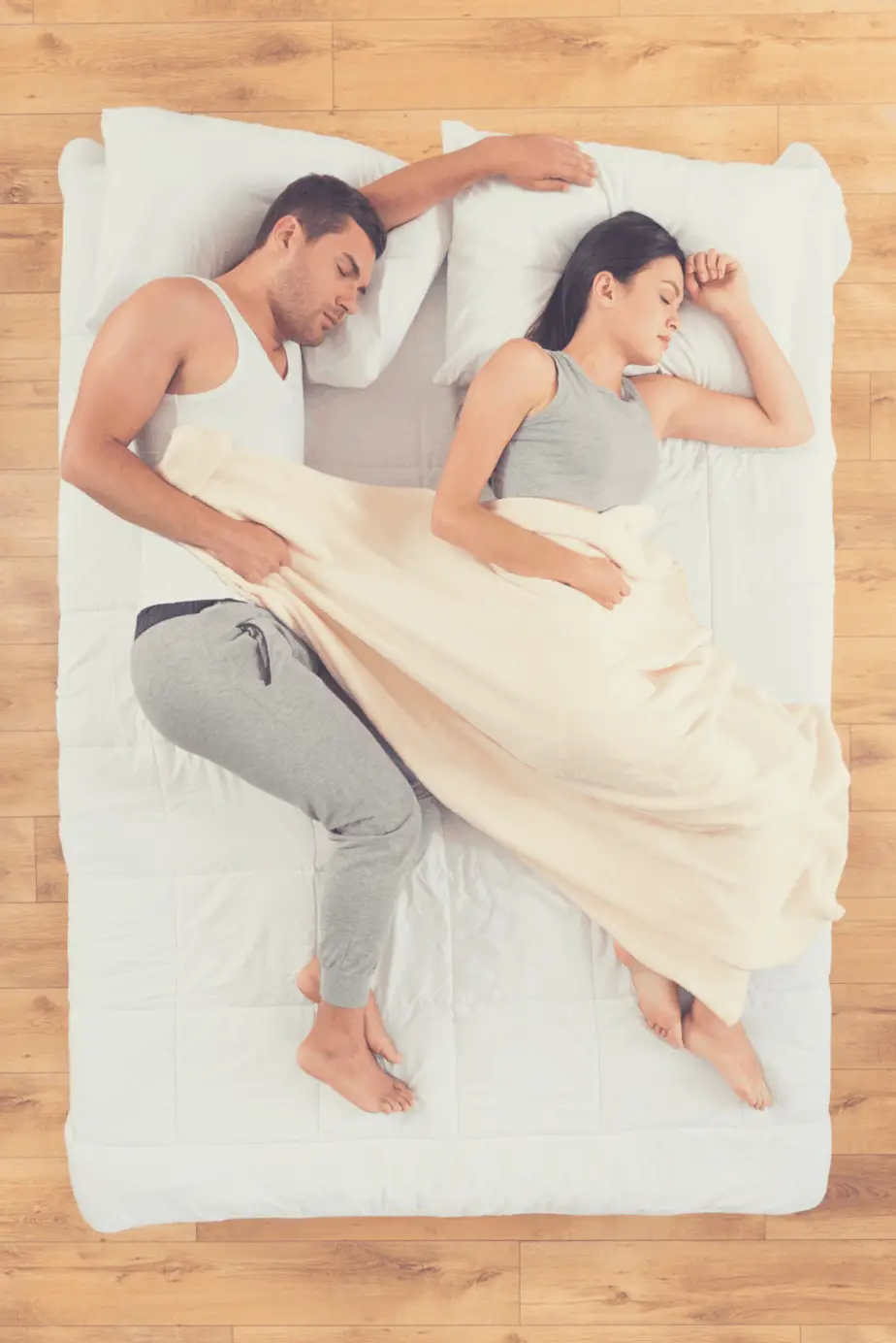 couple sleeping on a mattress on the floor