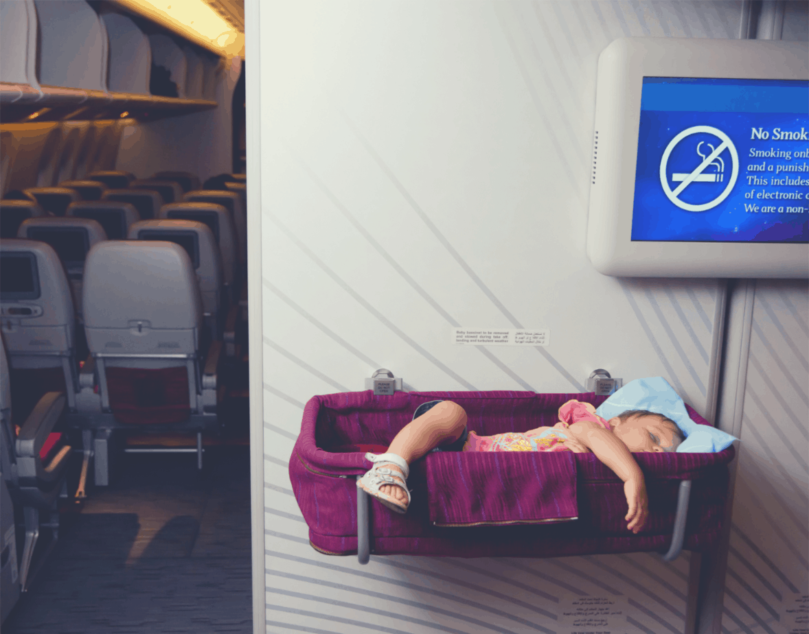2-year old sleeping soundly in a toddler bed while on a flight