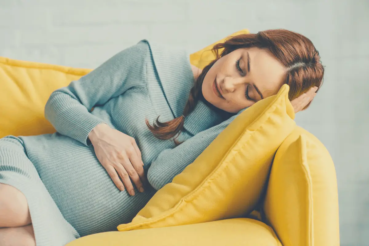 pregnant woman lying in a sofa on her left side