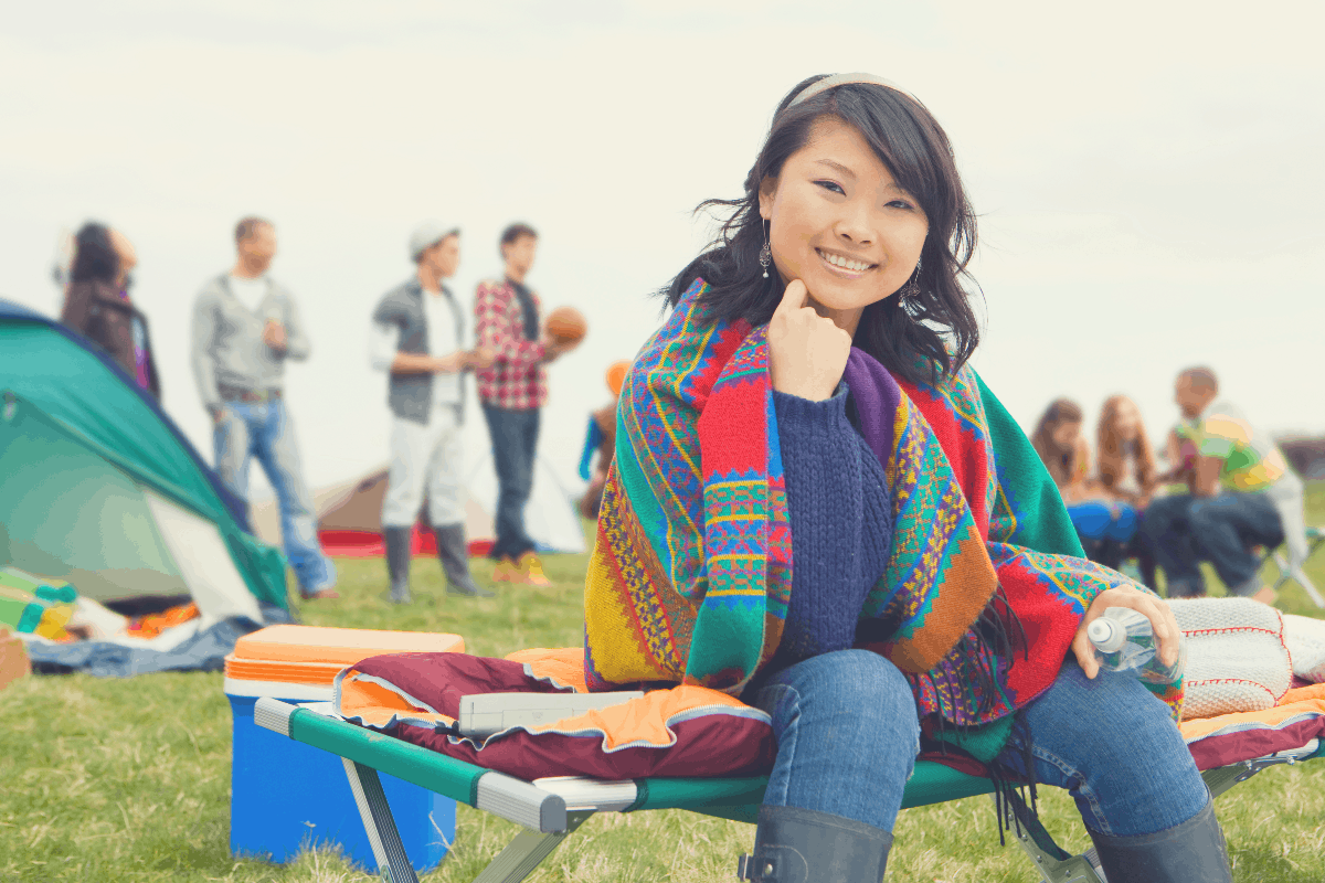 lady on a cot at an outdoor festival