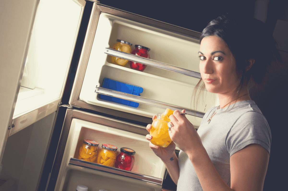 young woman eating a snack in the evening