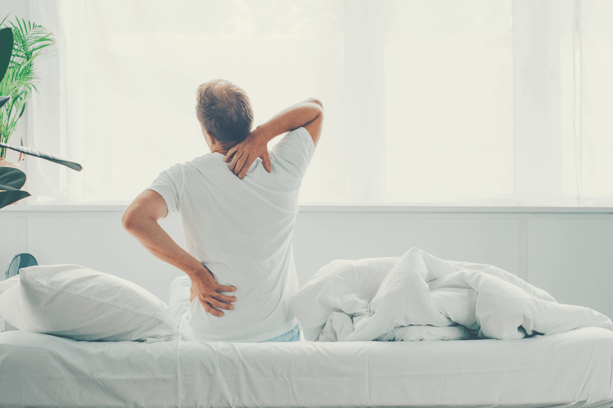 man waking up with backache