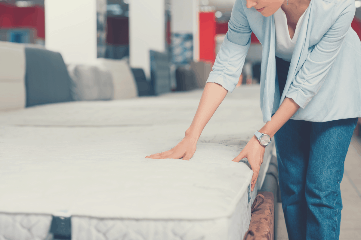 lady feeling the firmness of a mattress