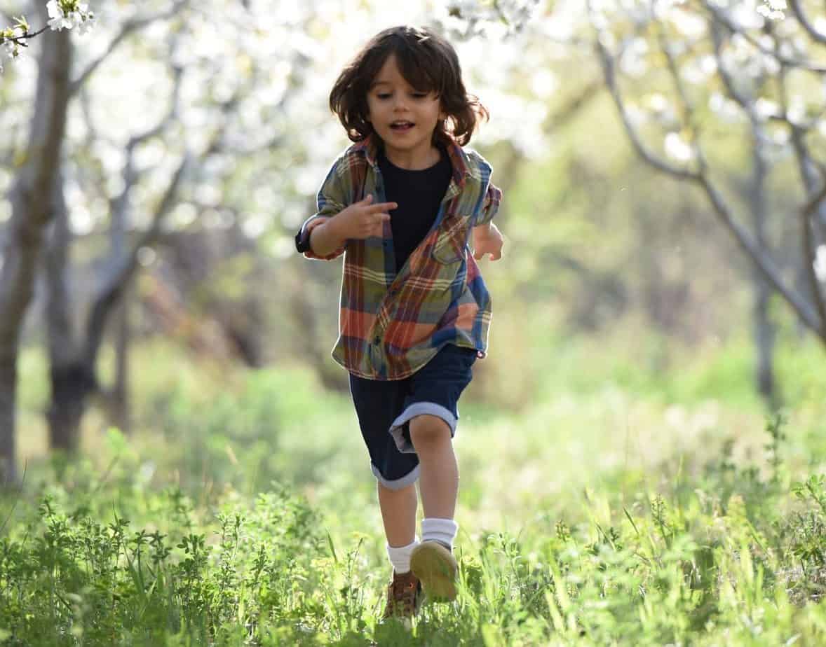kid running in the woods