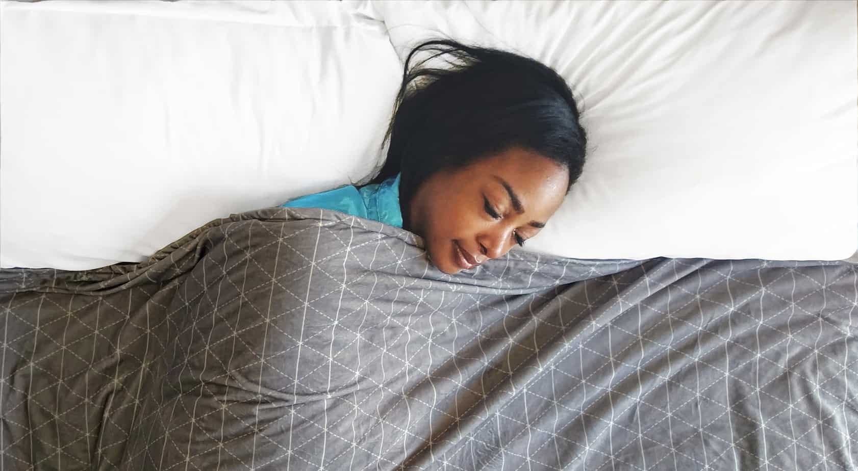 woman lying under a blanket