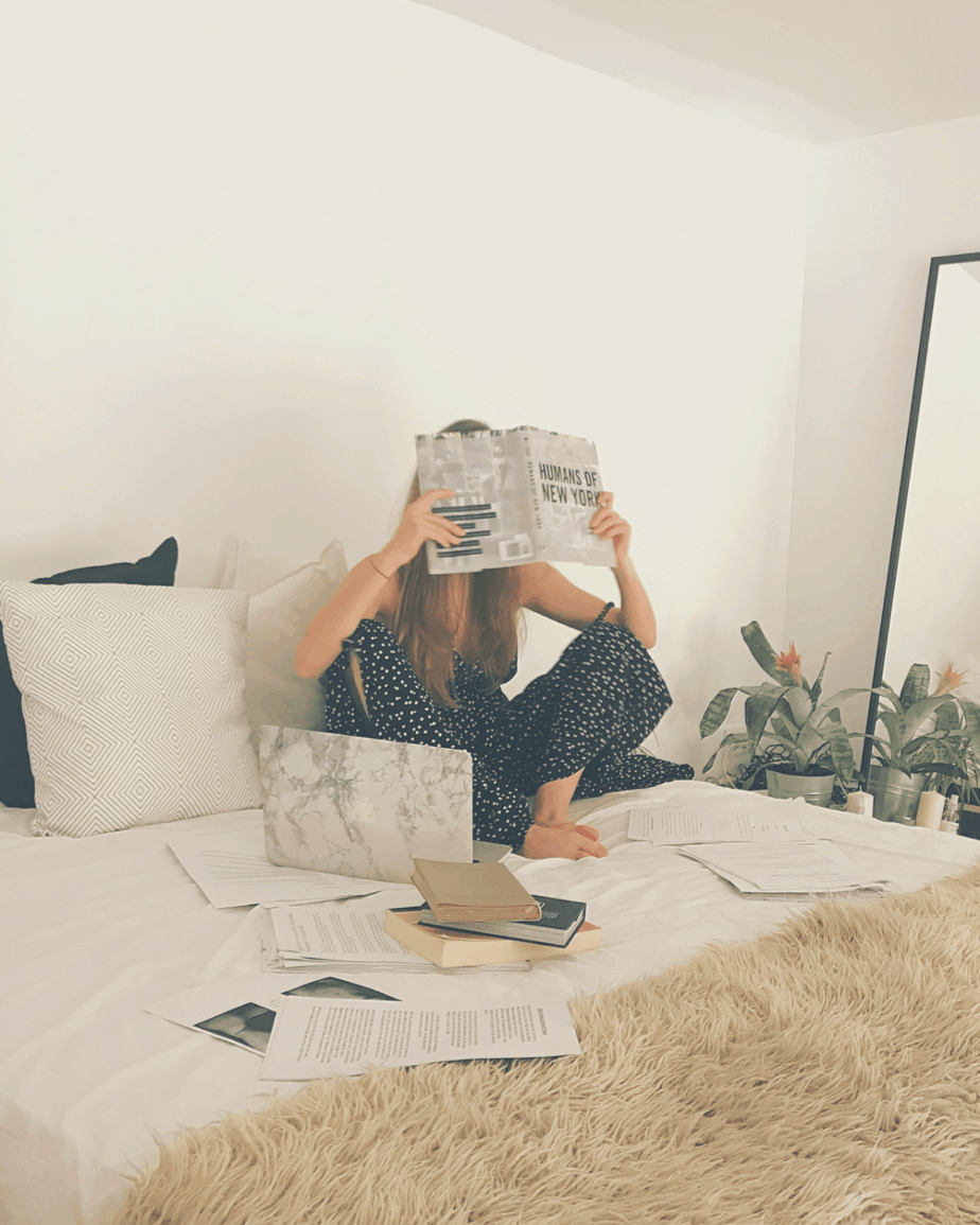 girl reading a book in bed