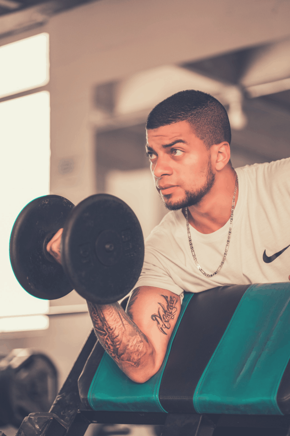 guy lifting dumb bells