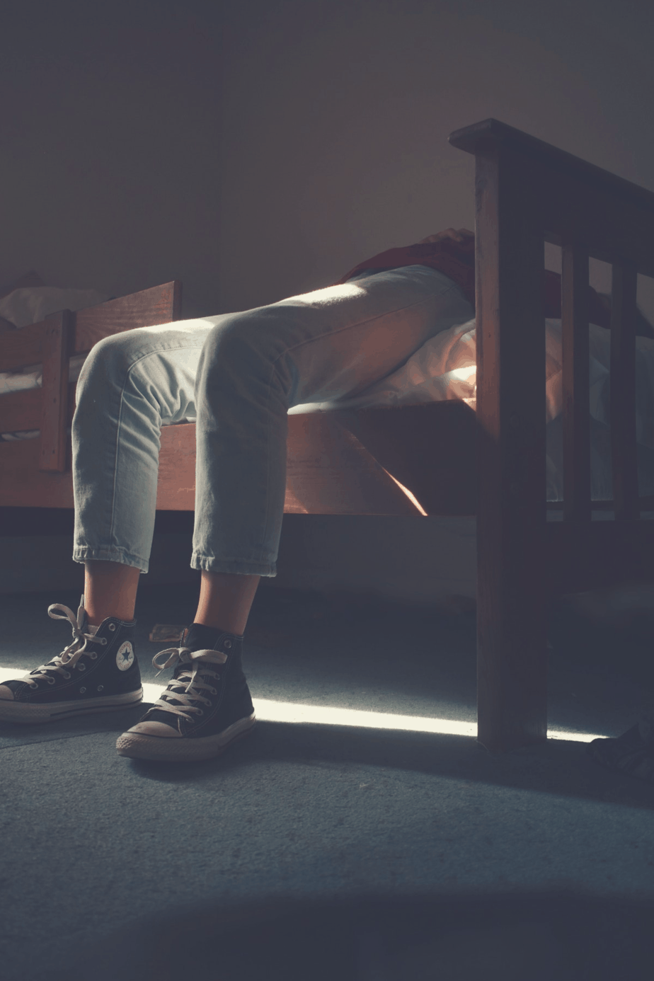 guy lying in bed with under-bed storage