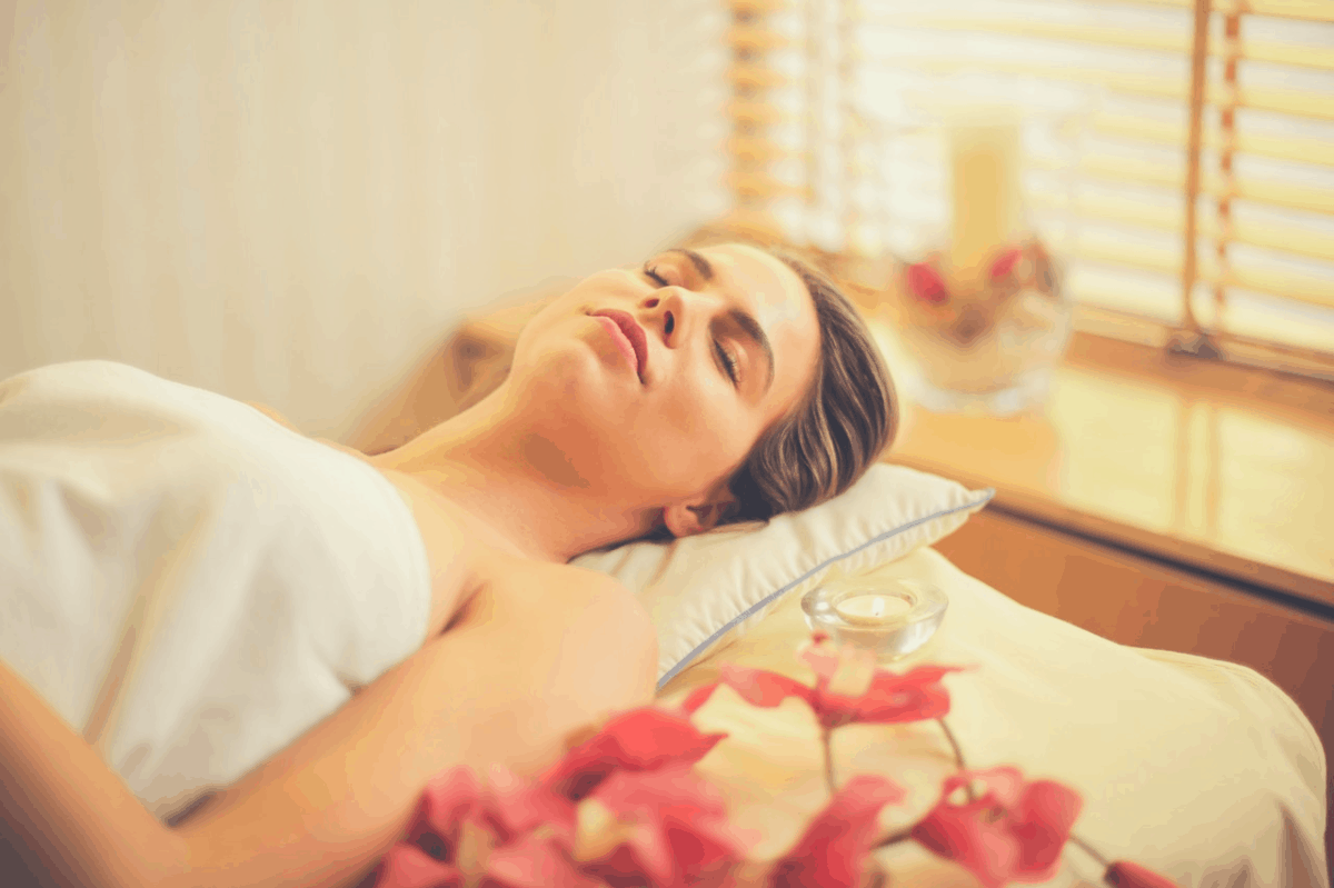 blonde woman lying down with her eyes closed