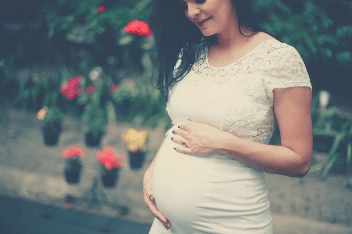 pregnant woman holding her tummy