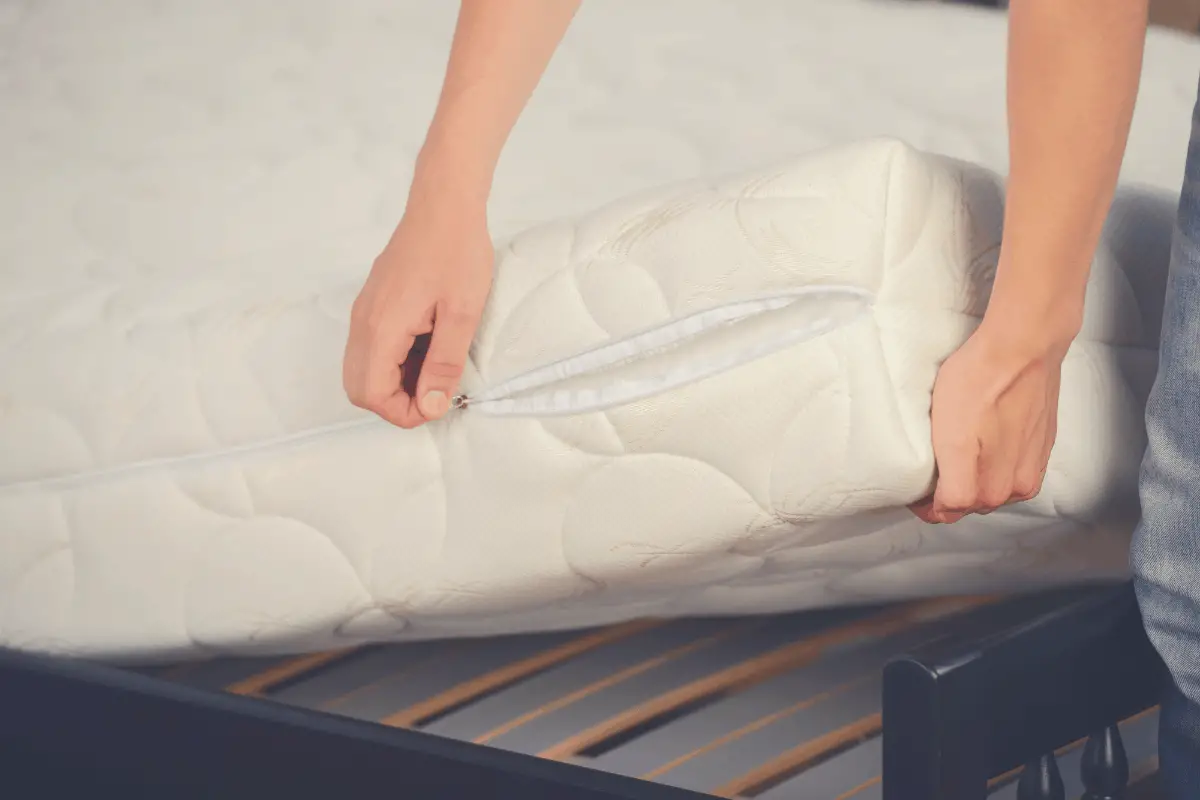 a cover being wrapped around a mattress