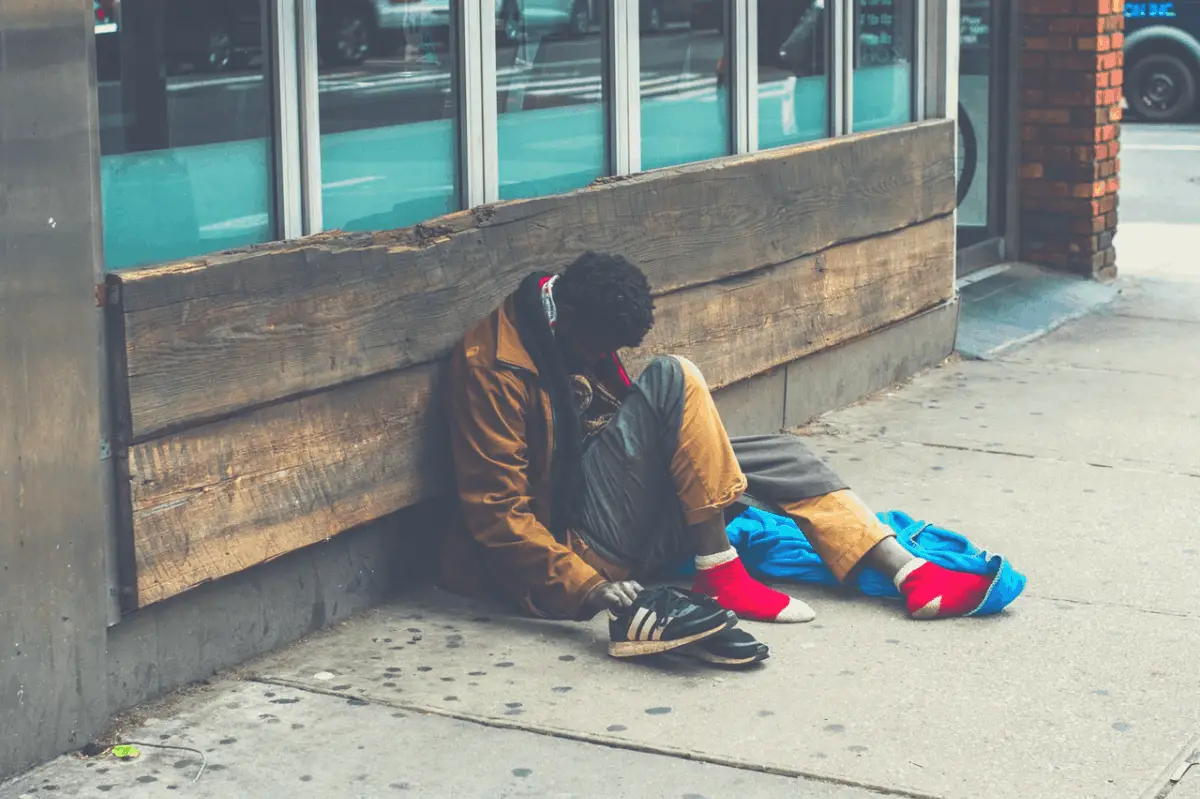 homeless black man sitting on the streets