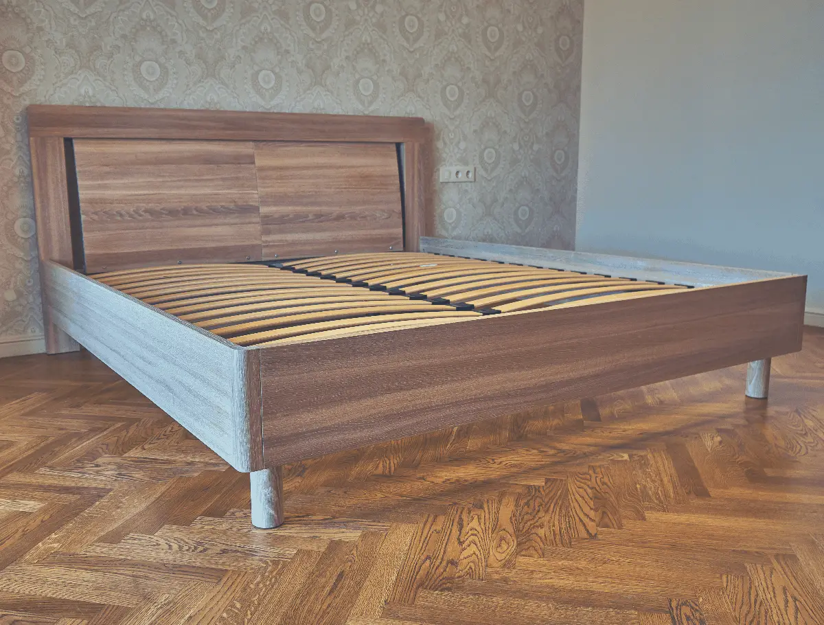 room with a wooden bed frame with frames