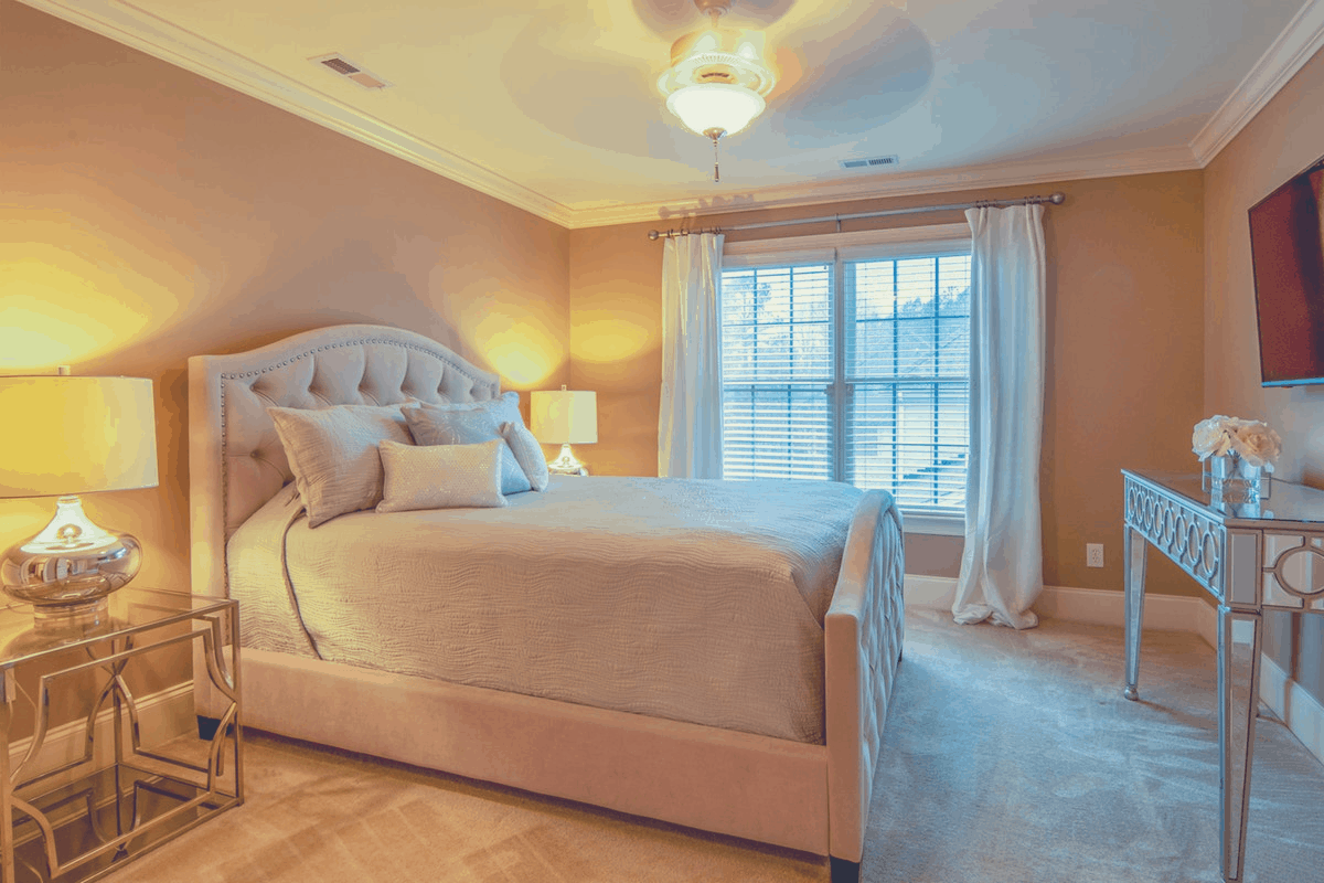 bedroom with comfy platform bed laid with sheets and 3 pillows