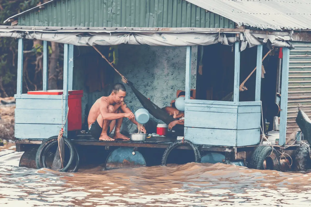 shirtless man in a flooded home