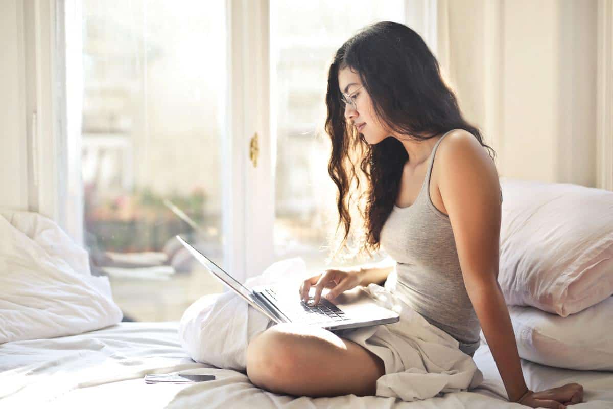 woman sitting in bed with laptop