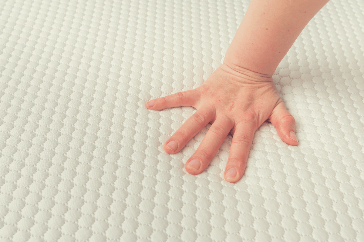 woman feeling the firmness of a mattress