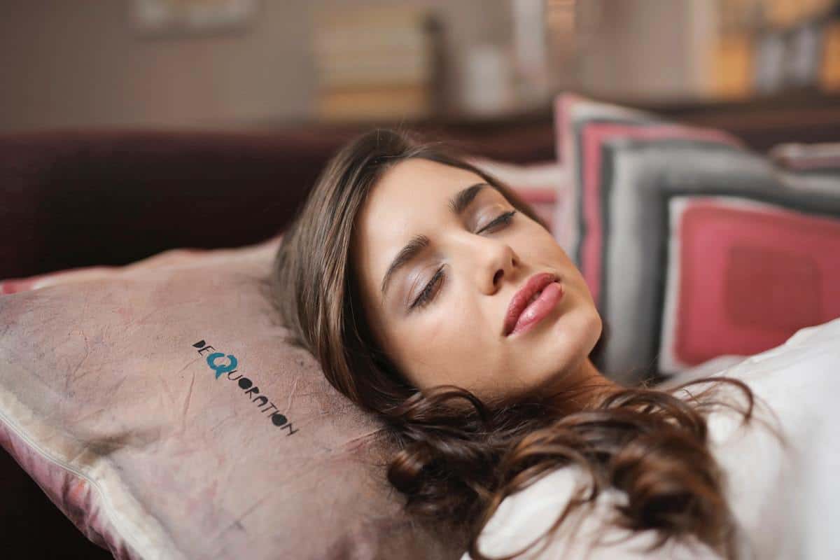 woman lying down on a pillow