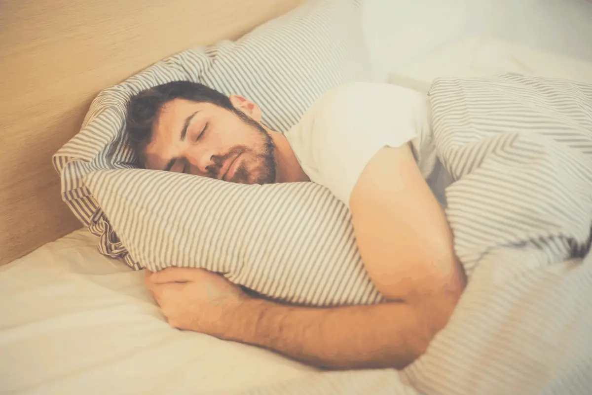 man lying on the side in bed