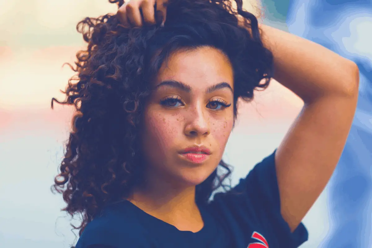 young woman with curly locks and facial acne