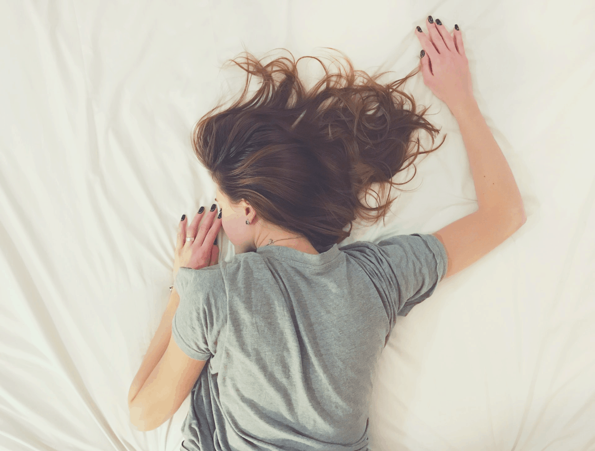 woman lying in bed alone