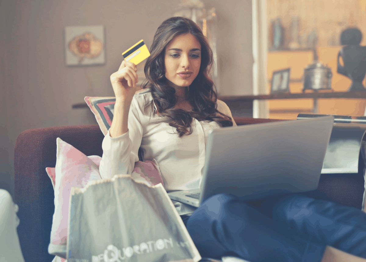 brunette with a credit card for online shopping