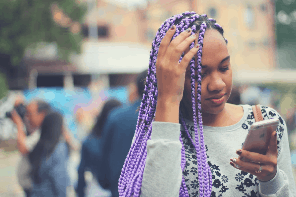 lady looking at her iPhone in public