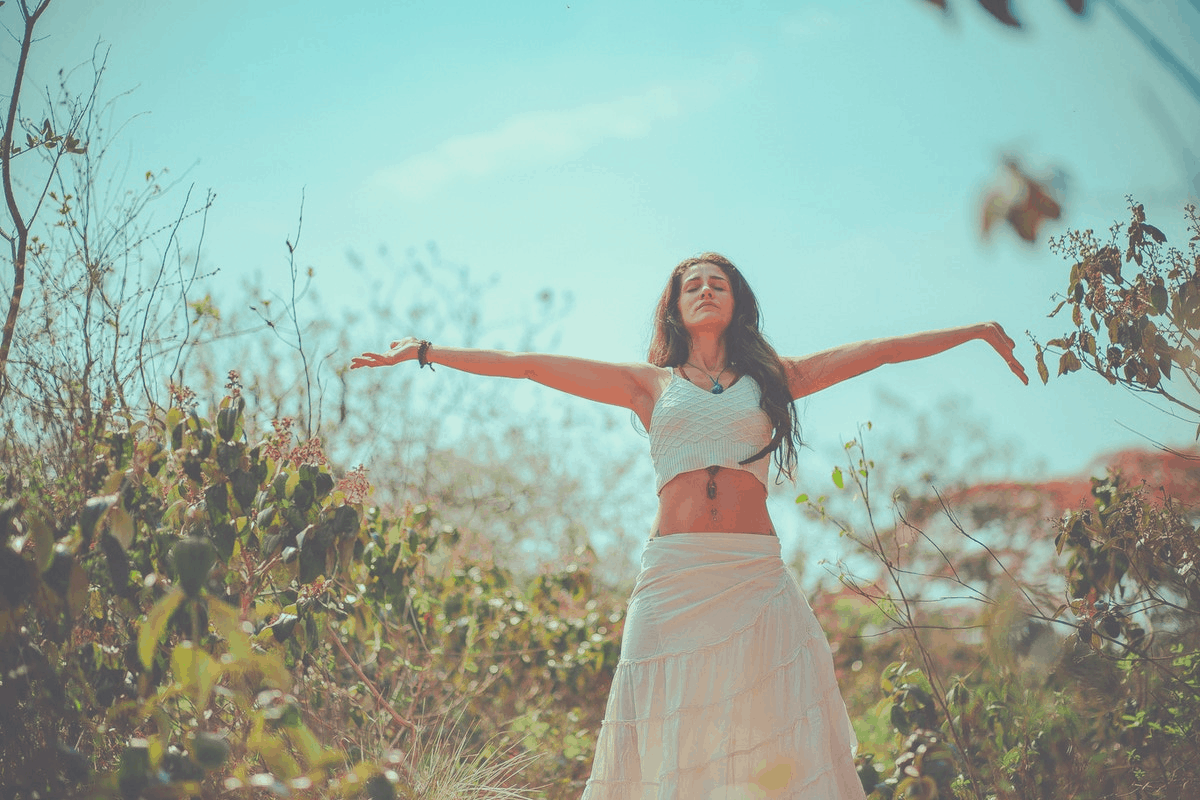 brunette woman meditating outdoors