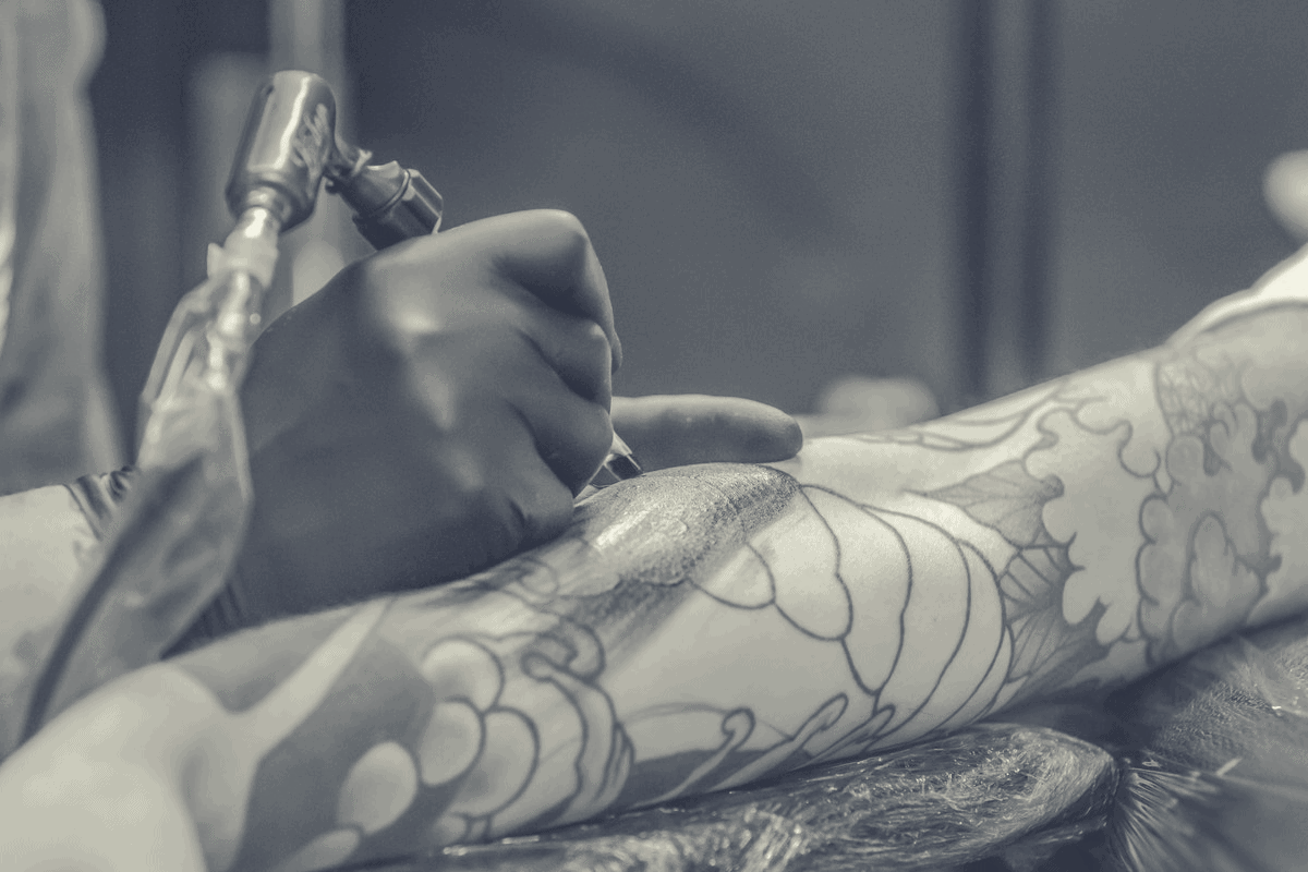 person undergoing an arm tattoo