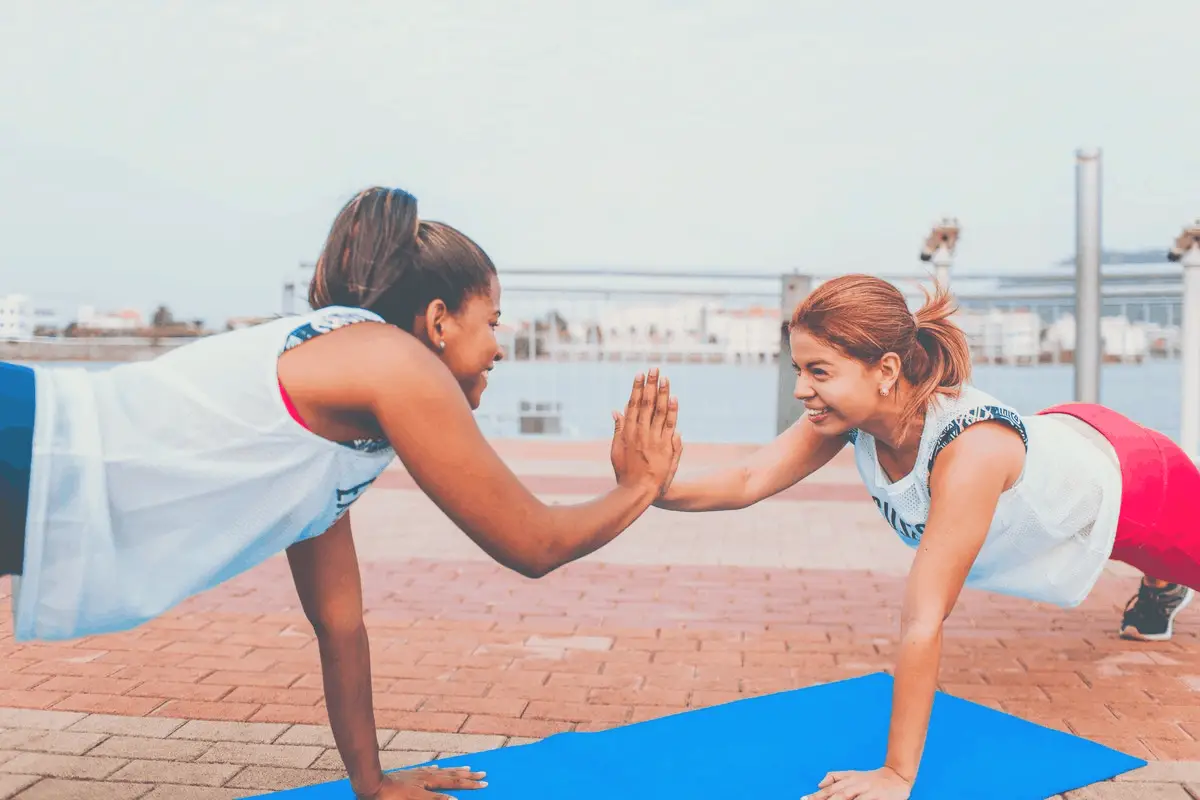 2 women smiling while exercising