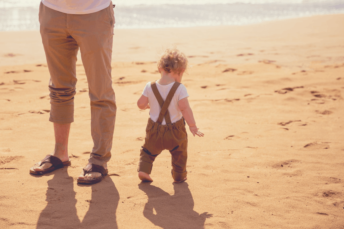 man and baby in the beach