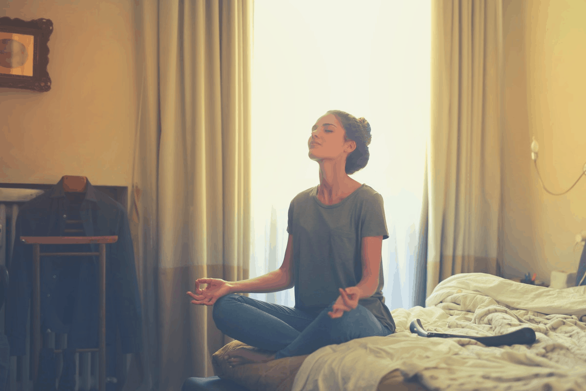 woman meditating in the bedroom