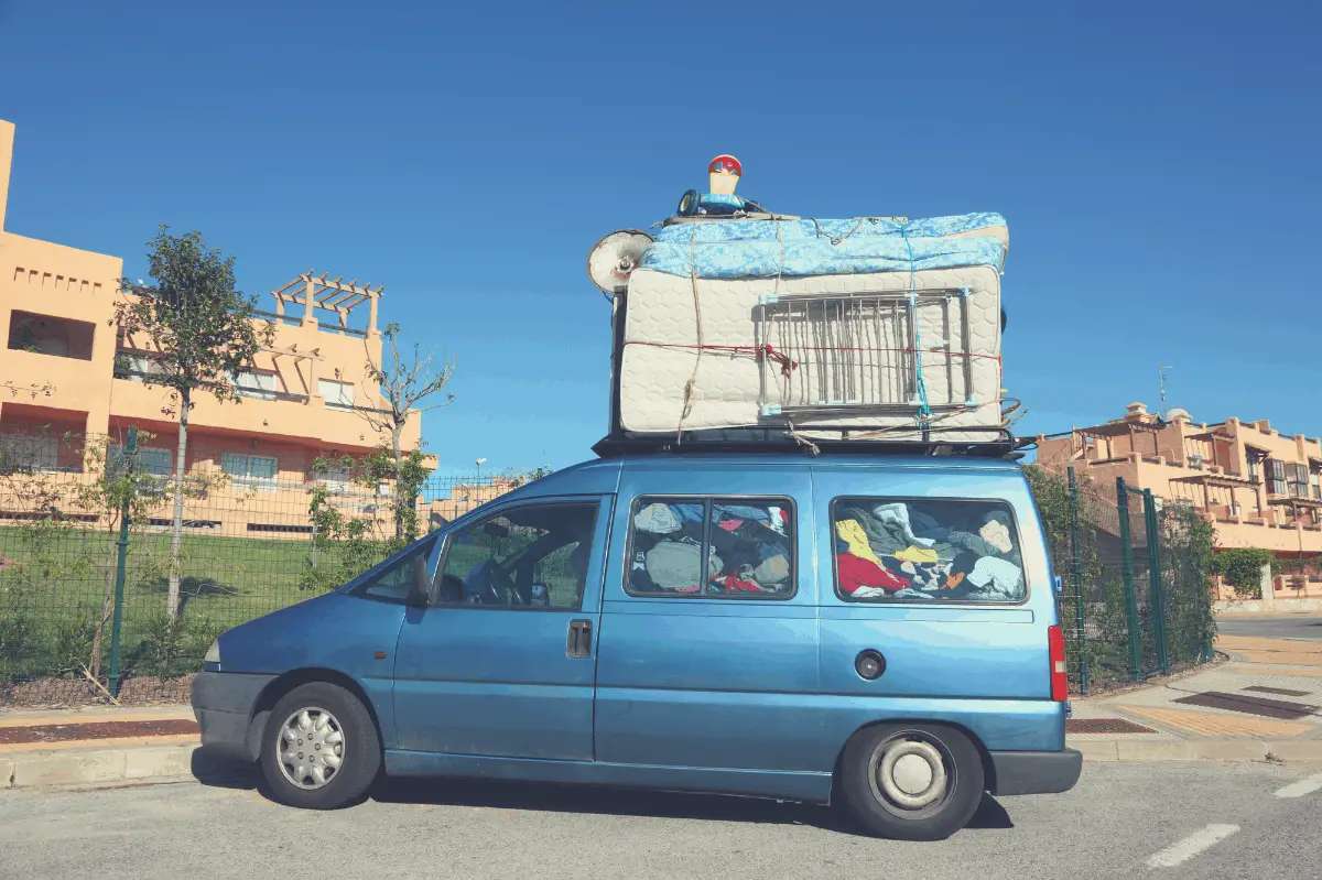mattress loaded on top of a minivan without compression