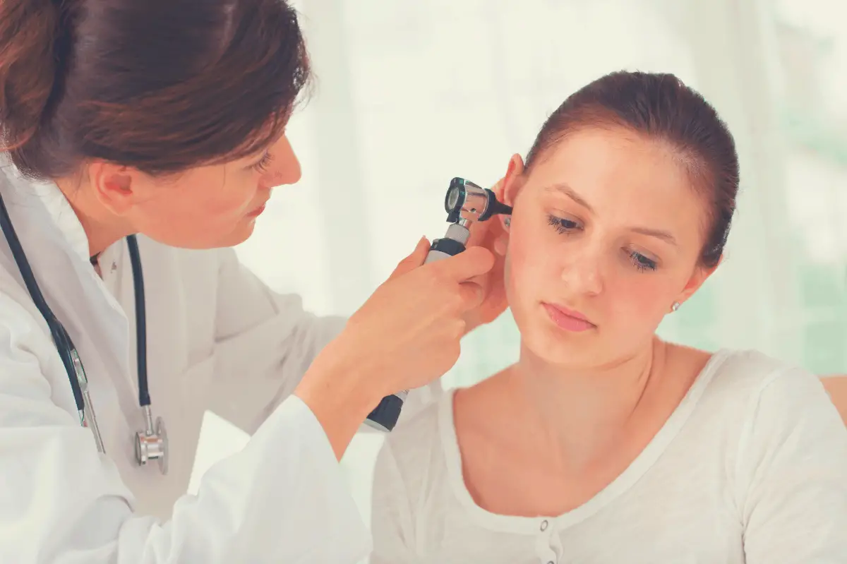 doctor checking a patient's ear for infections