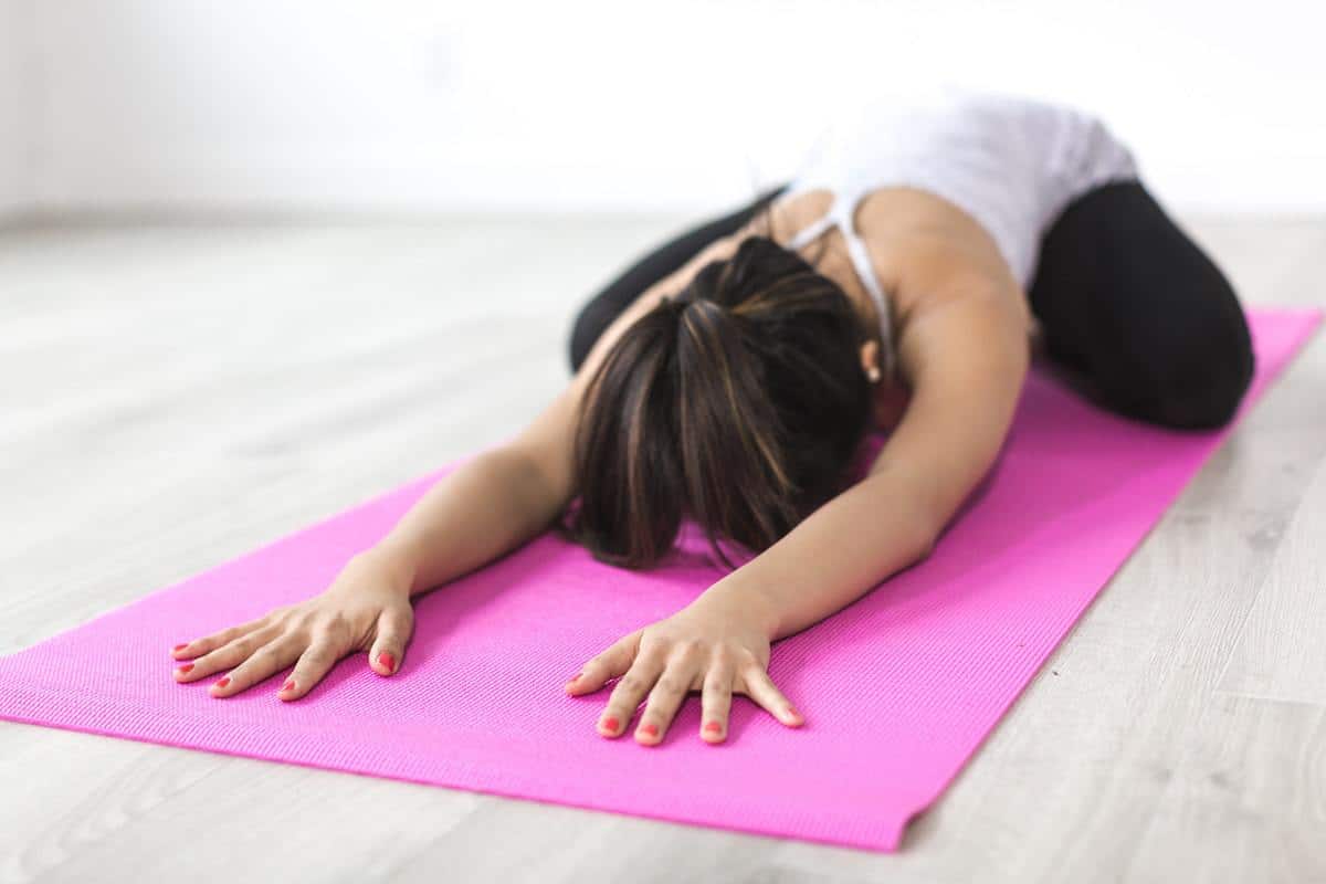 woman stretching on a yoga mat