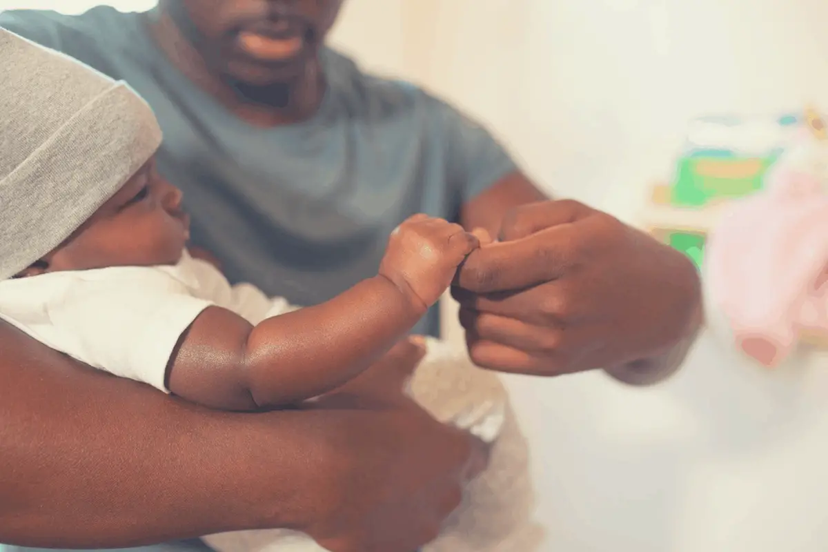 black man holding a baby