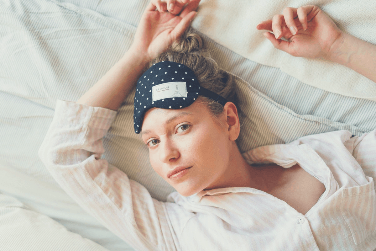 blonde woman lying down in her pajamas