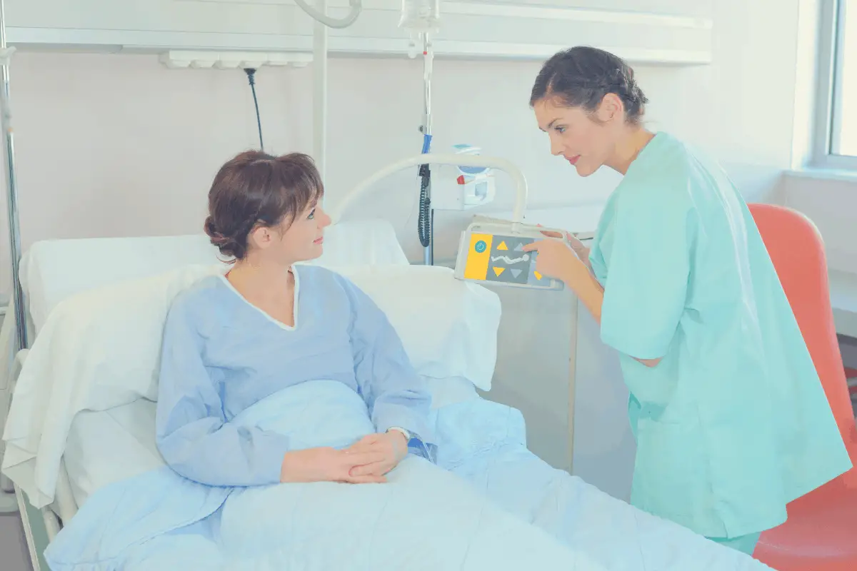 patient in an adjustable bed talking to a nurse