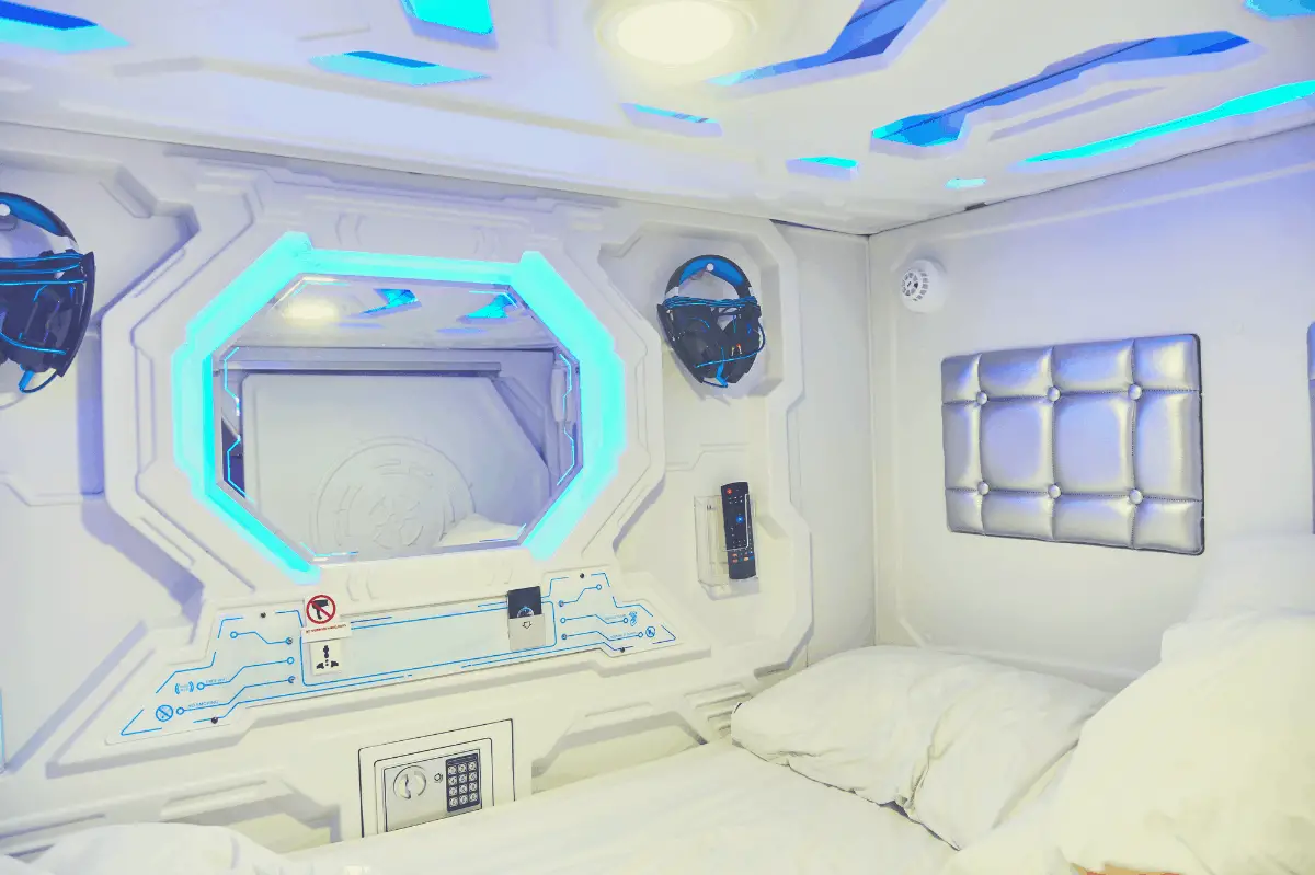 the interior of a sleep capsule with bed and pillows