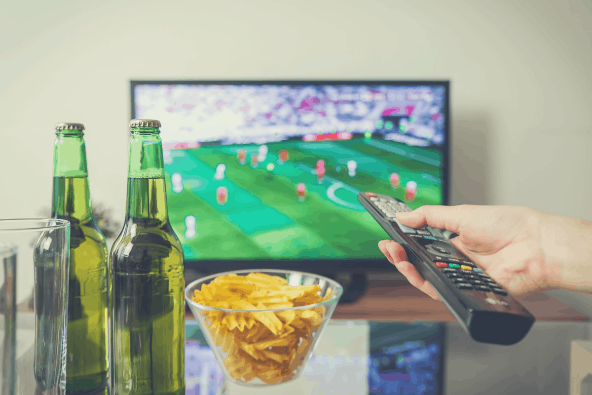 2 beer bottles in front of a TV