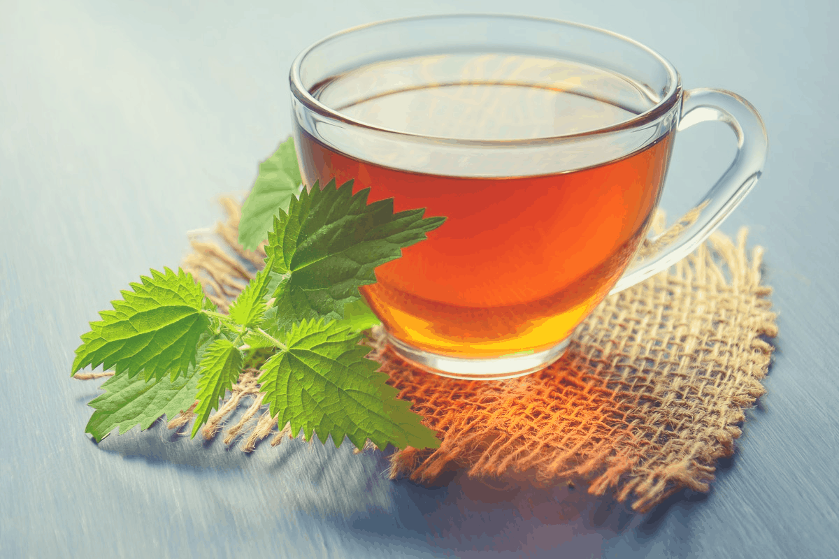 glass of tea with a green leaf