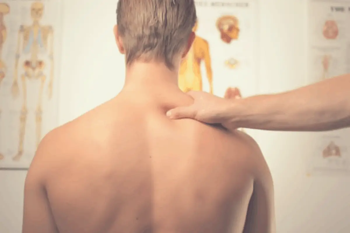 chiropractor massaging a patient's neck