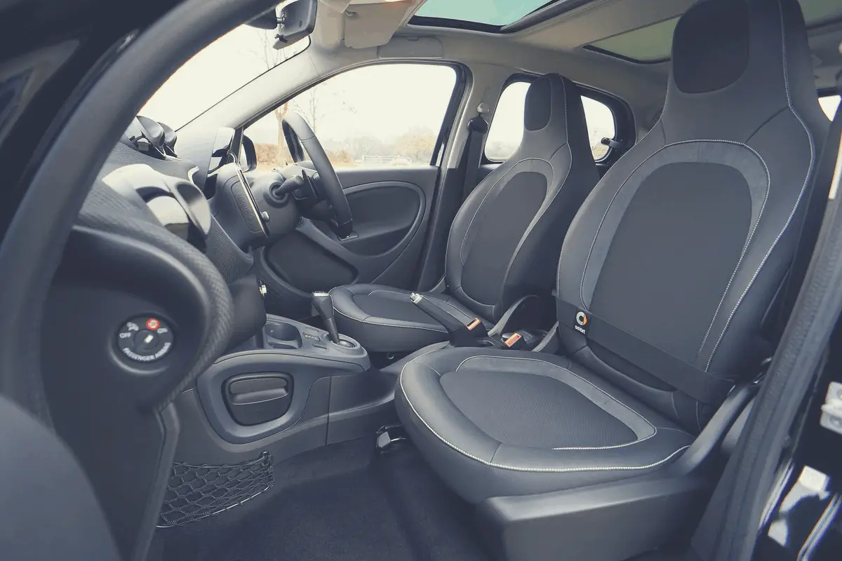 the interior of a car showing the front seats and steering wheel